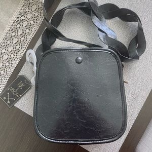 CrossBody black faux leather purse.